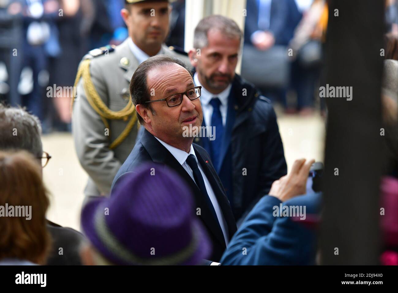 French President Francois Hollande greets family members of victims