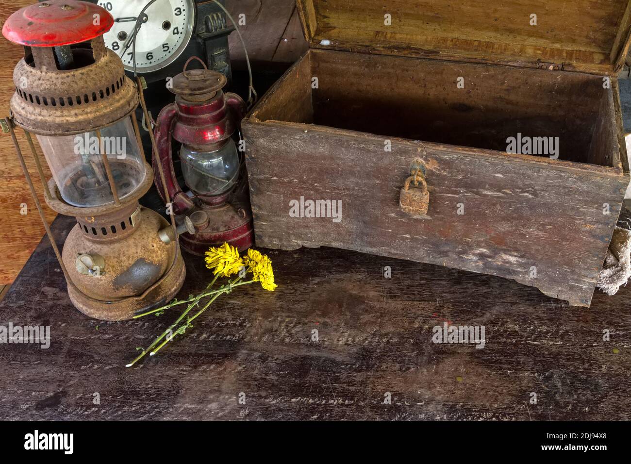 Vintage oil lamp ,old wooden box ,dry chrysanthemum flower and alarm