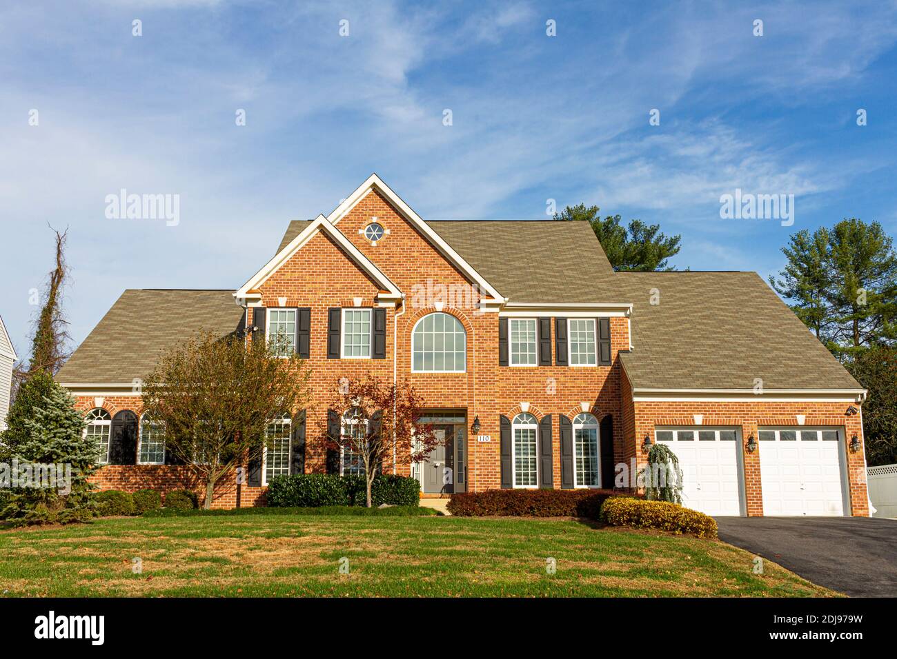 Rockville, Maryland USA 11-10-2020: A modern spacious upscale two story brick single family home with a large front yard and two car attached garage. Stock Photo