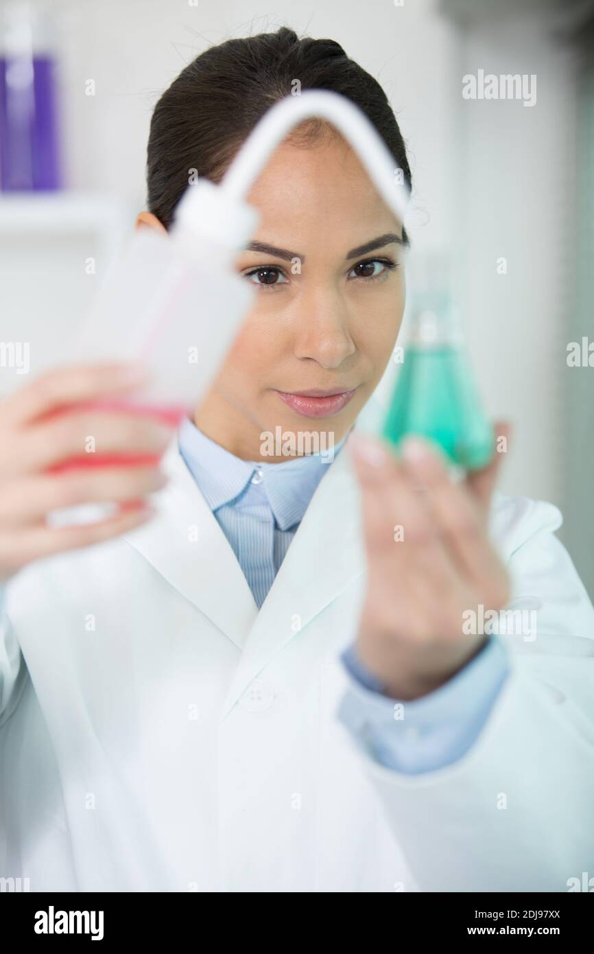 female scientist using dropper during science experiment Stock Photo