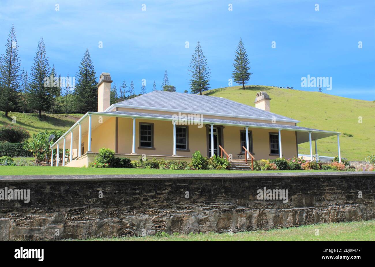 Norfolk Island, Colonial-Georgian House, Quality Row Number 7, World Heritage Area, Kingston. Endemic Norfolk Island Pines up on Hill. Stock Photo