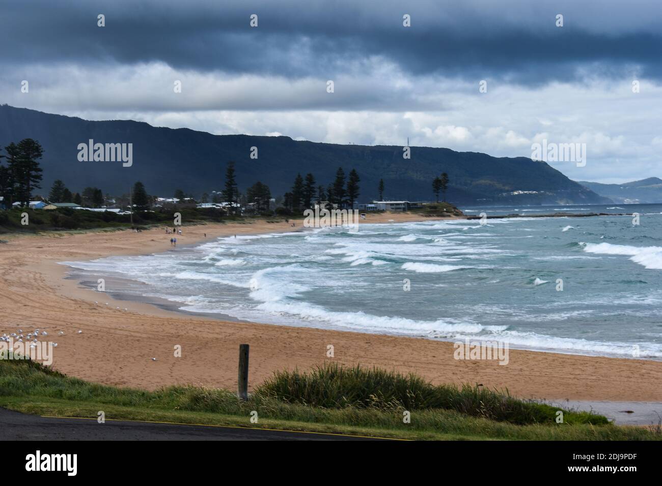 bulli beach on a cloudy day with waves coming in Stock Photo