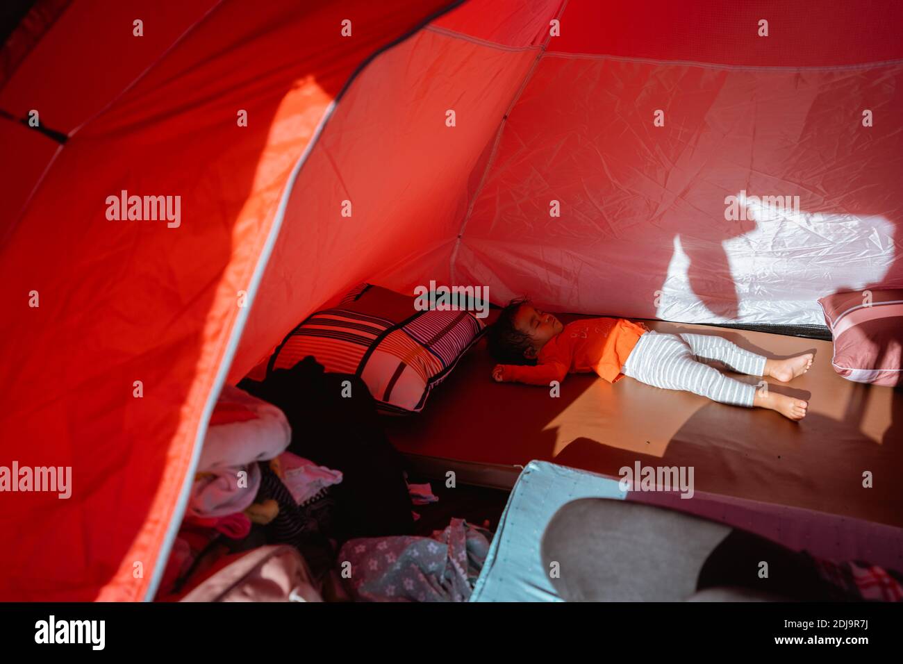 Portrait of a little girl sleeping soundly in a camp tent at morning