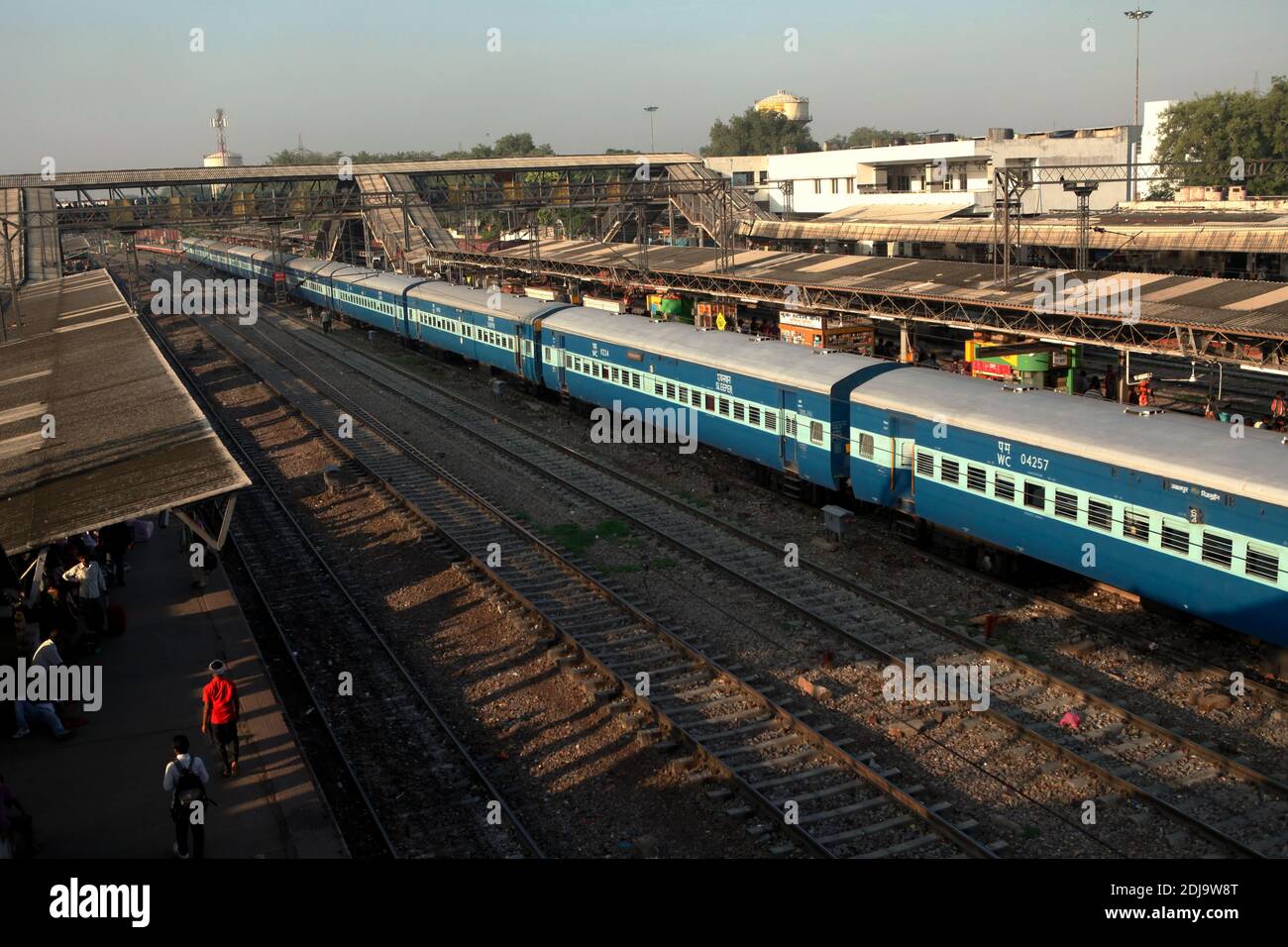 Railroad tracks, train, and morning view of New Delhi Railway Station in Delhi, India. Stock Photo