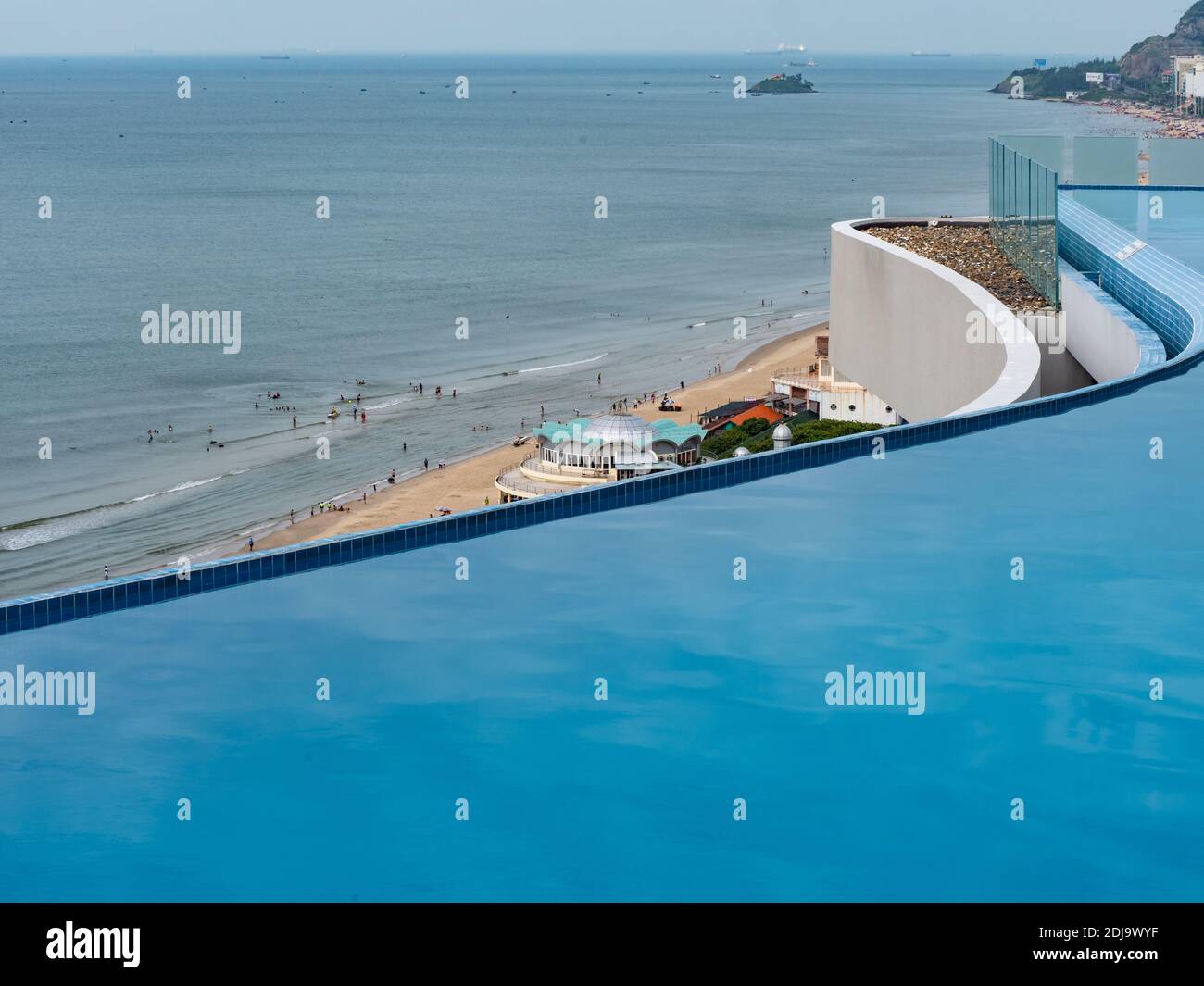 Rooftop eternity pool at Cao Hotel on Bai Sau or Back Beach in Vung Tau in the Bang Ria-Vung Tau Province of South Vietnam. Restaurant pavilion on the Stock Photo