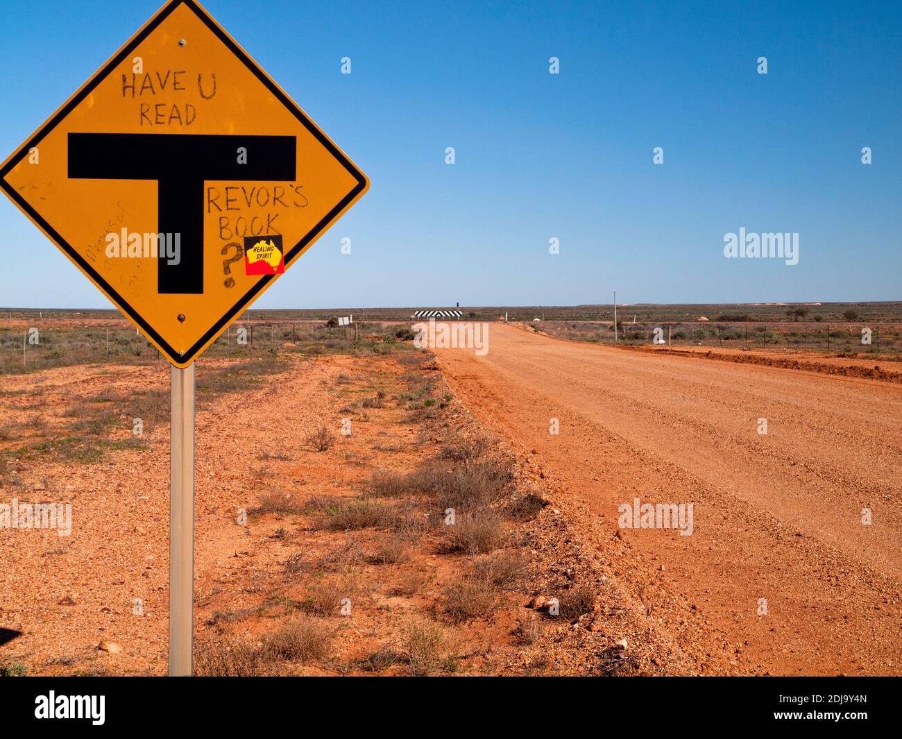 'Have you read Trevor's book?' graffiti on a T-intersection road sign at Coober Pedy, South Australia Stock Photo
