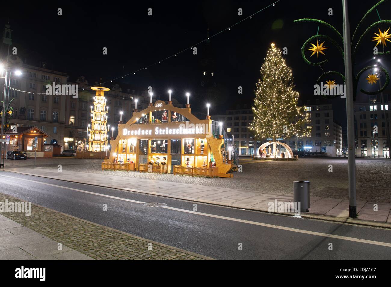 Dresden, Germany. 14th Dec, 2020. An oversized candle arch, a pyramid and a Christmas tree stand on the empty Altmarkt. Saxony will go into the hard lockdown from 14 December 2020. Public life will remain shut down until January 10, 2021. In addition to most shops, day-care centres, schools and after-school care centres are also closed. As in spring, emergency care is available for children of parents of systemically important professions. The Free State of Bavaria is considered a Corona focal point nationwide. Credit: Sebastian Kahnert/dpa-Zentralbild/dpa/Alamy Live News Stock Photo