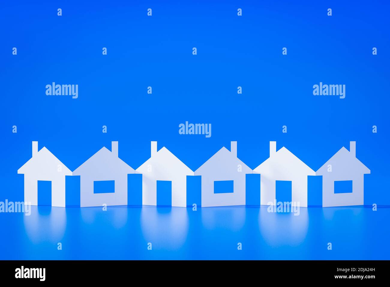 3d illustration of a paper cutout row of houses blue background Stock Photo