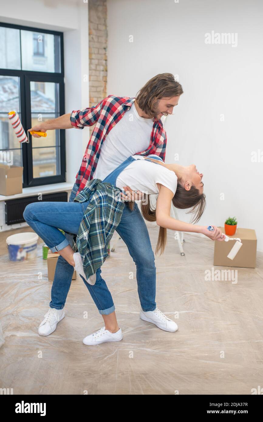 Young couple dancing in their new house Stock Photo