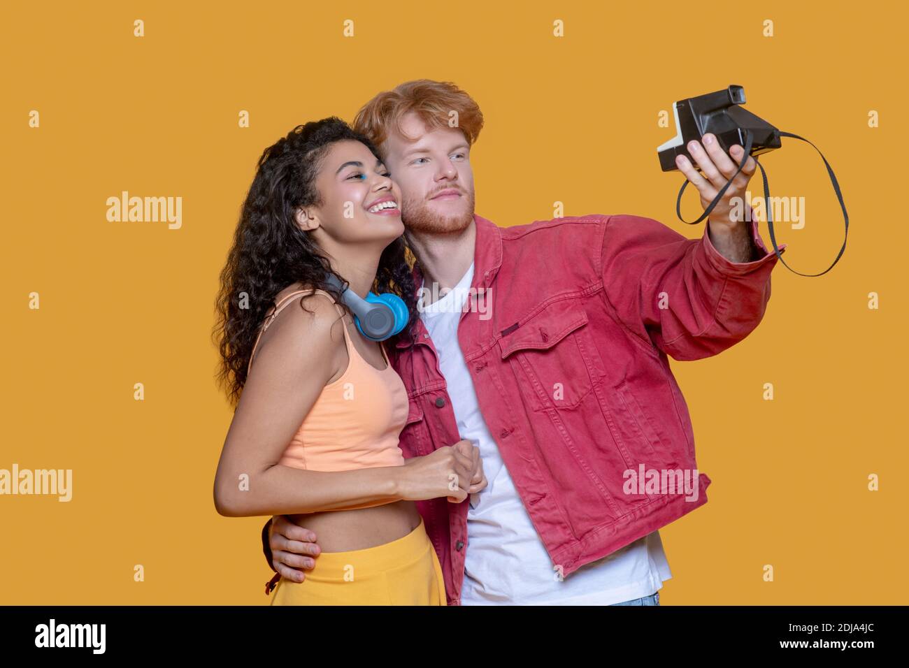 Good-looking young couple making selfie on old camera Stock Photo
