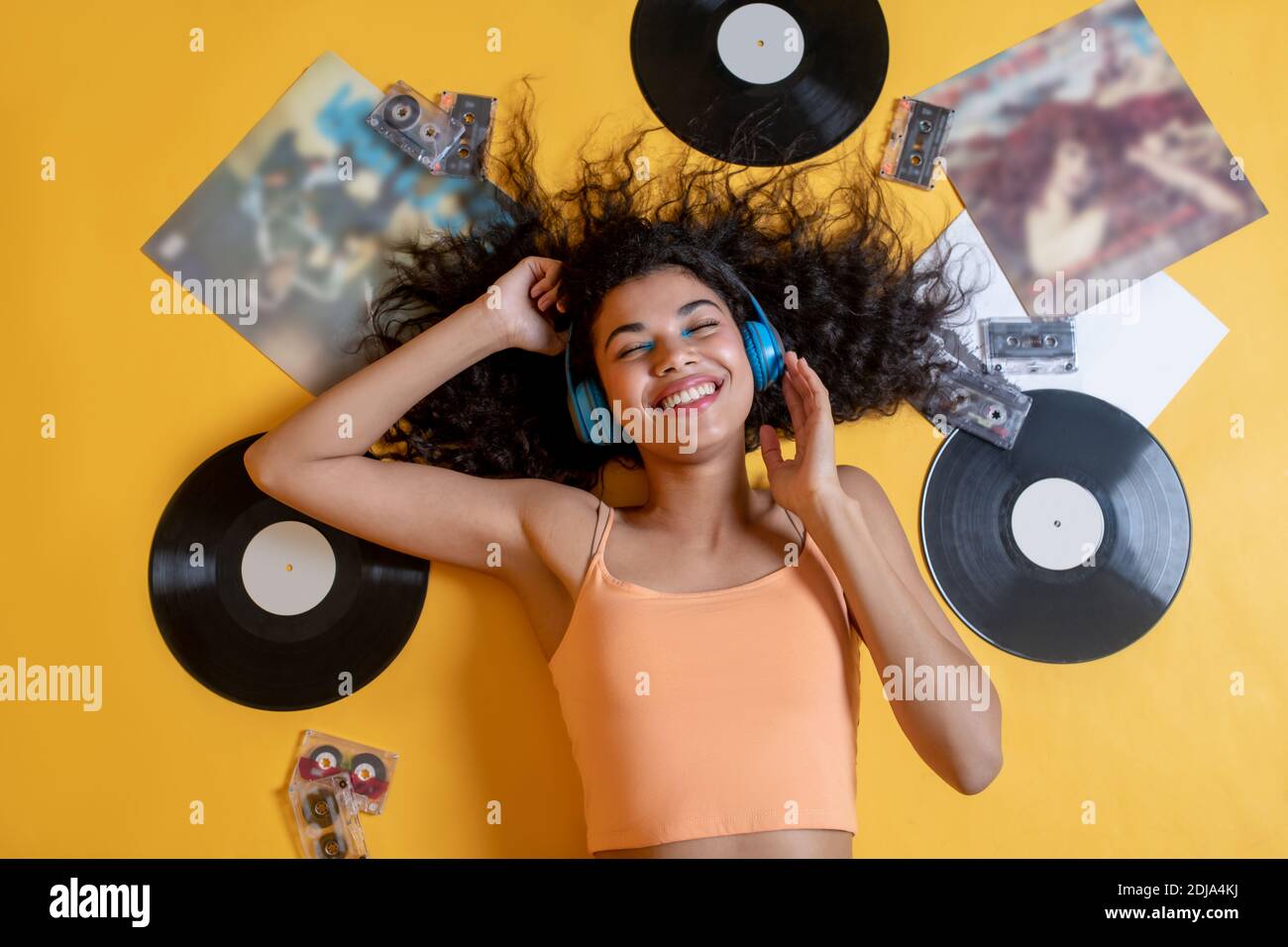 Pretty young girl lying on the floor and listening to music Stock Photo ...