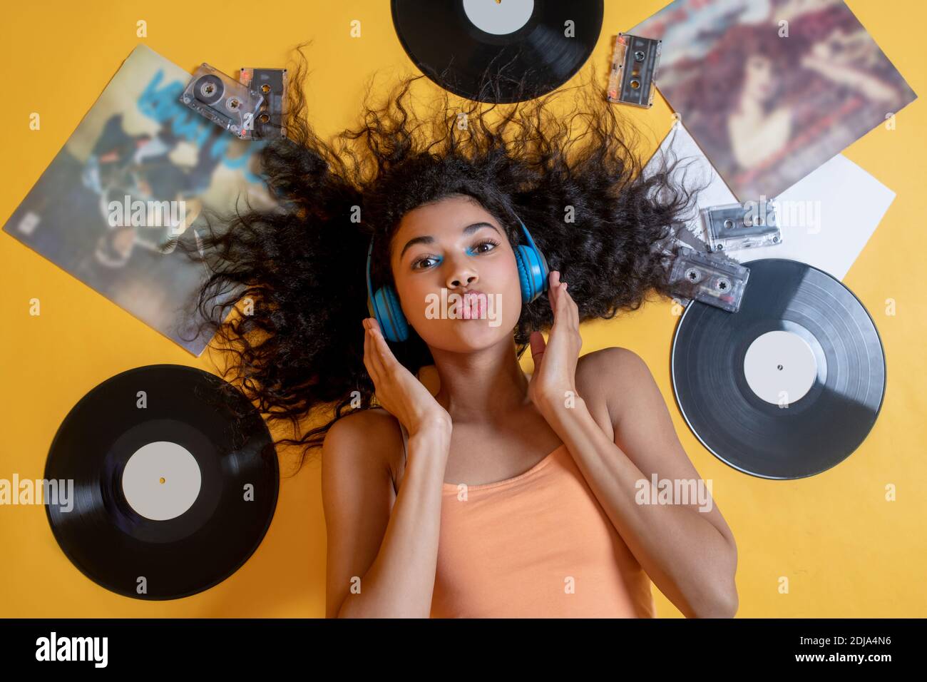 Pretty young girl lying on the floor and listening to music Stock Photo ...