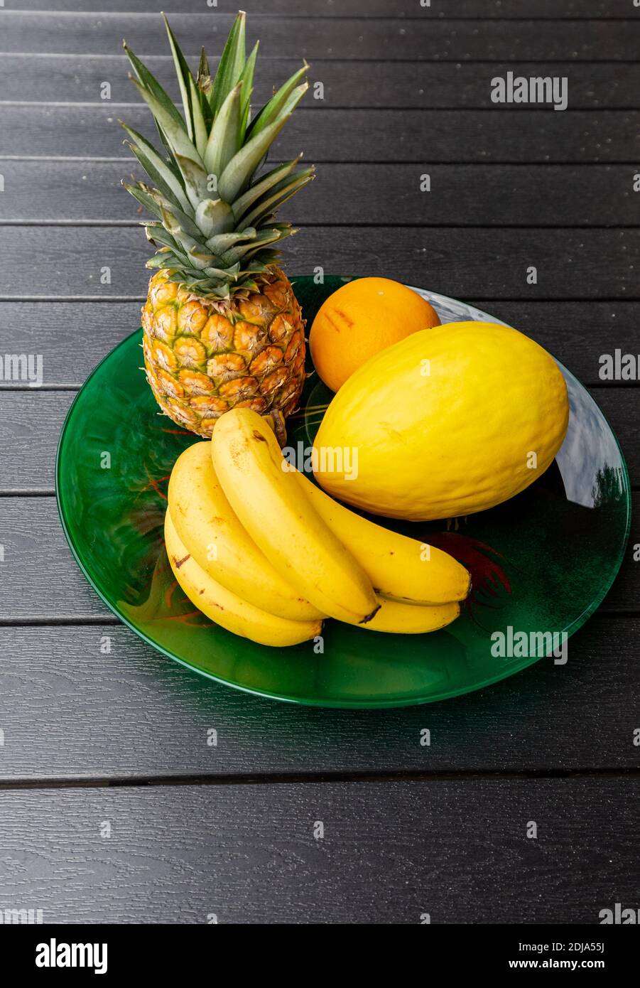 Assortment of fresh exotic fruits on  black table Stock Photo
