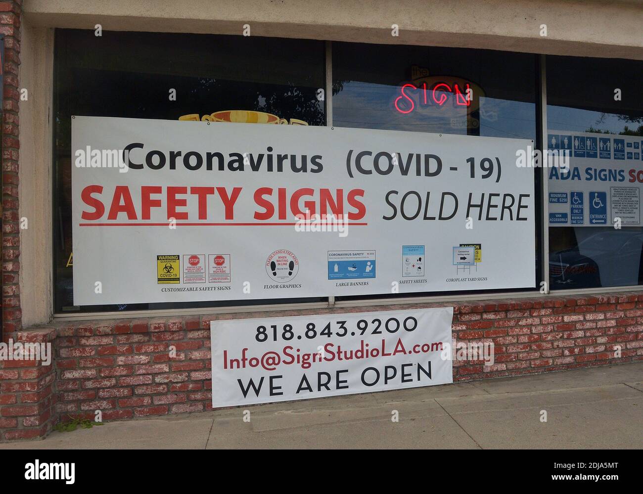 A sign making business promotes the sales of coronavirus (COVID-19) safety signs in its window in Burbank, California on Sunday, December 13, 2020. As many businesses struggle through the pandemic, some have found a different niche in the wake of the crisis.   Photo by Jim Ruymen/UPI Stock Photo