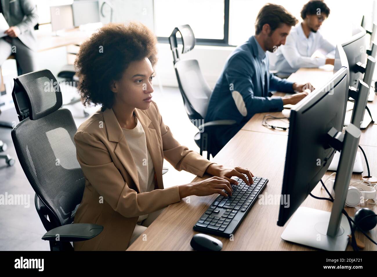 Programmers cooperating brainstorming at information technology company ...