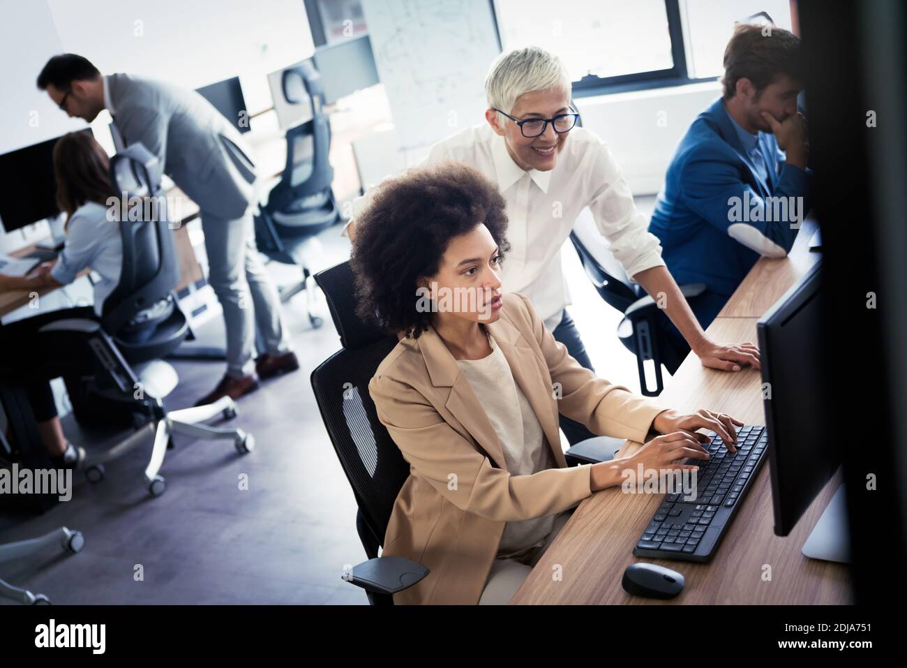 Portrait of successful business team working in office Stock Photo - Alamy