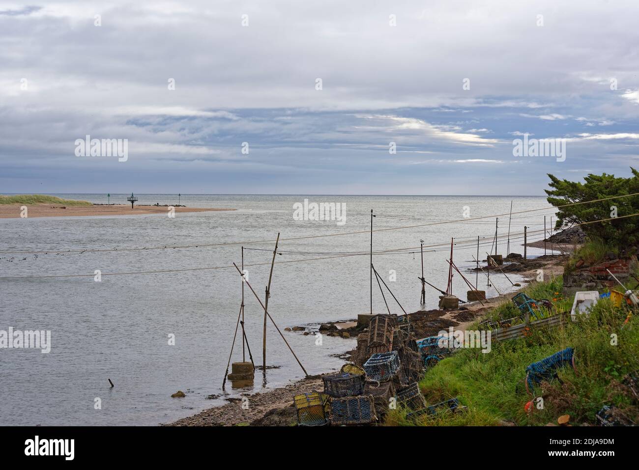 The old traditional Washing Lines of the Fishermans cottages over the beach at Ferryden on the East Coast of Scotland at High Tide. Stock Photo