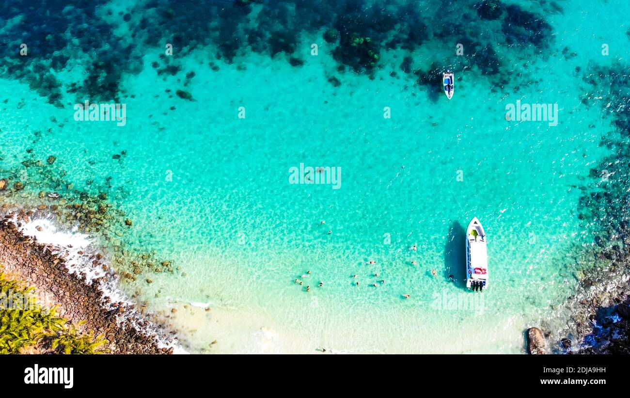 Aerial view of beautiful landscape, tourism boats, and people swimming ...