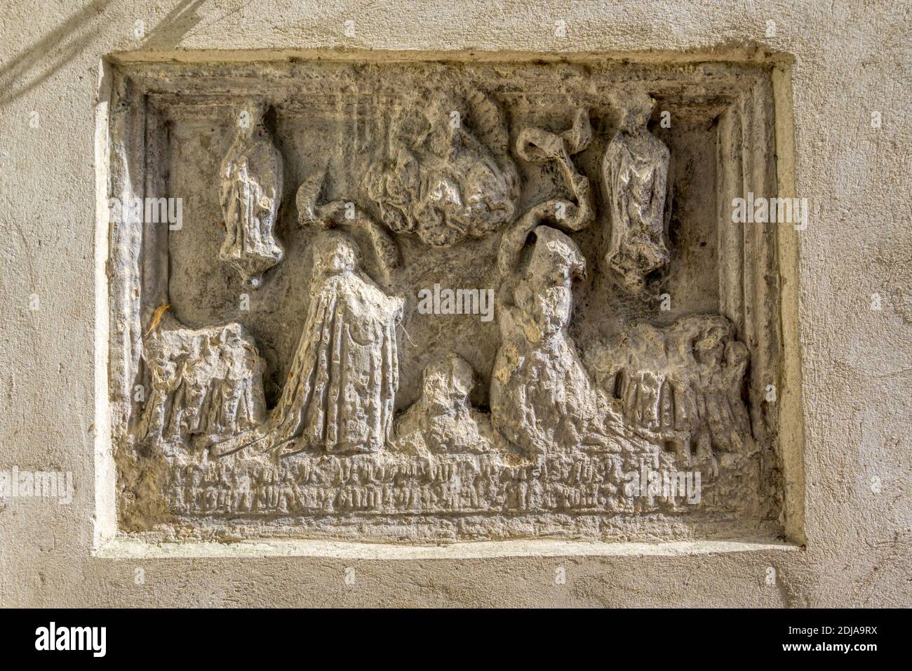 An early 16th century stone carving on the outside wall of the Oxmarket Gallery, Chichester. Originally St Andrew, Oxmarket church. Stock Photo