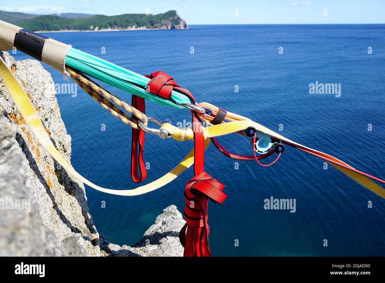 Part of climbing equipment on the background of the blue sea and island ...
