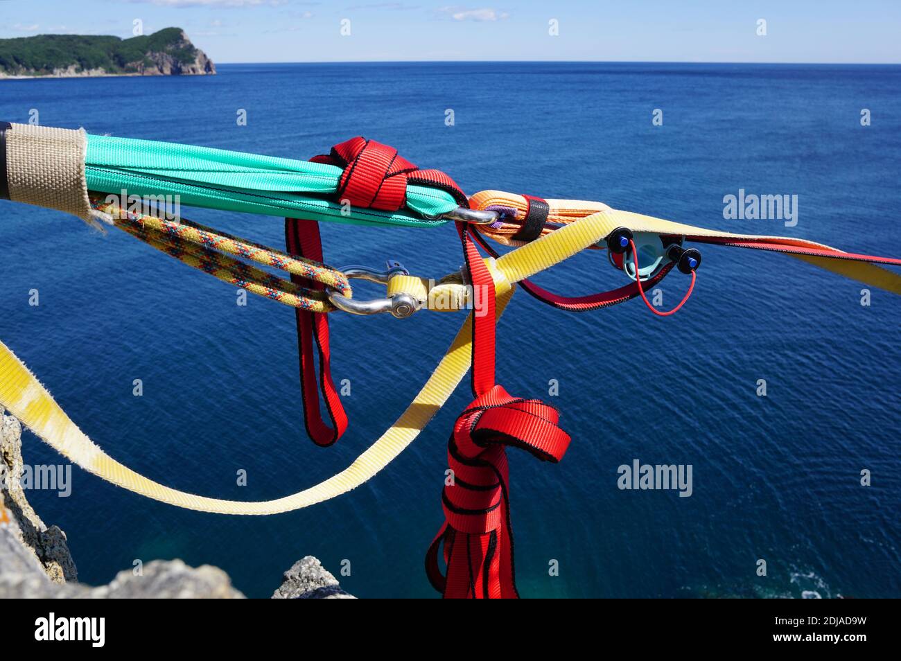 Part of climbing equipment on the background of the blue sea and island ...