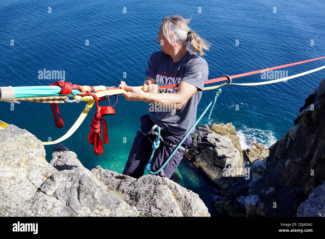 Slackliner holds on to the rope and prepares to go on the highline