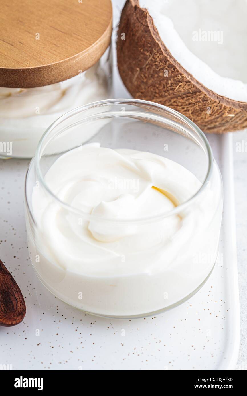 Vegan coconut yogurt in glass jars, white background Stock Photo Alamy