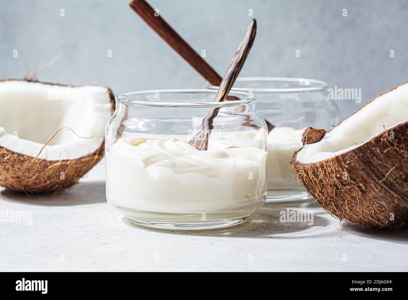 Vegan coconut yogurt in glass jars, white background Stock Photo Alamy
