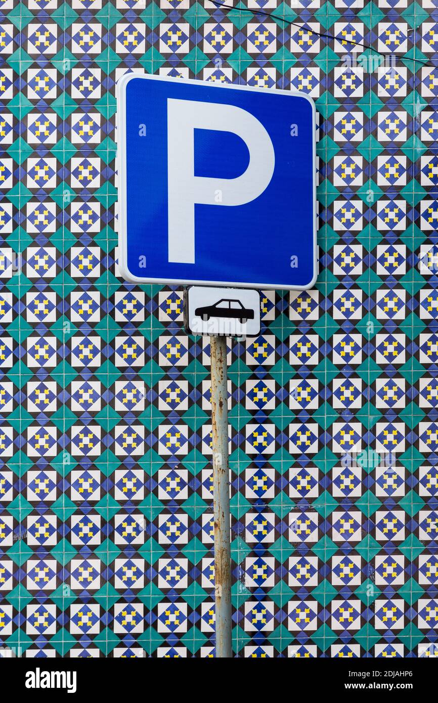 Blue parking sign in front of blue and green Azulejo tiles, Lisbon