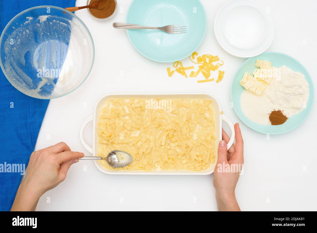 step-by-step recipe for the holiday of Hanukkah, a traditional Kugel pie with noodles and custard, sand crumbs on top. ingredients in the dishes on a Stock Photo