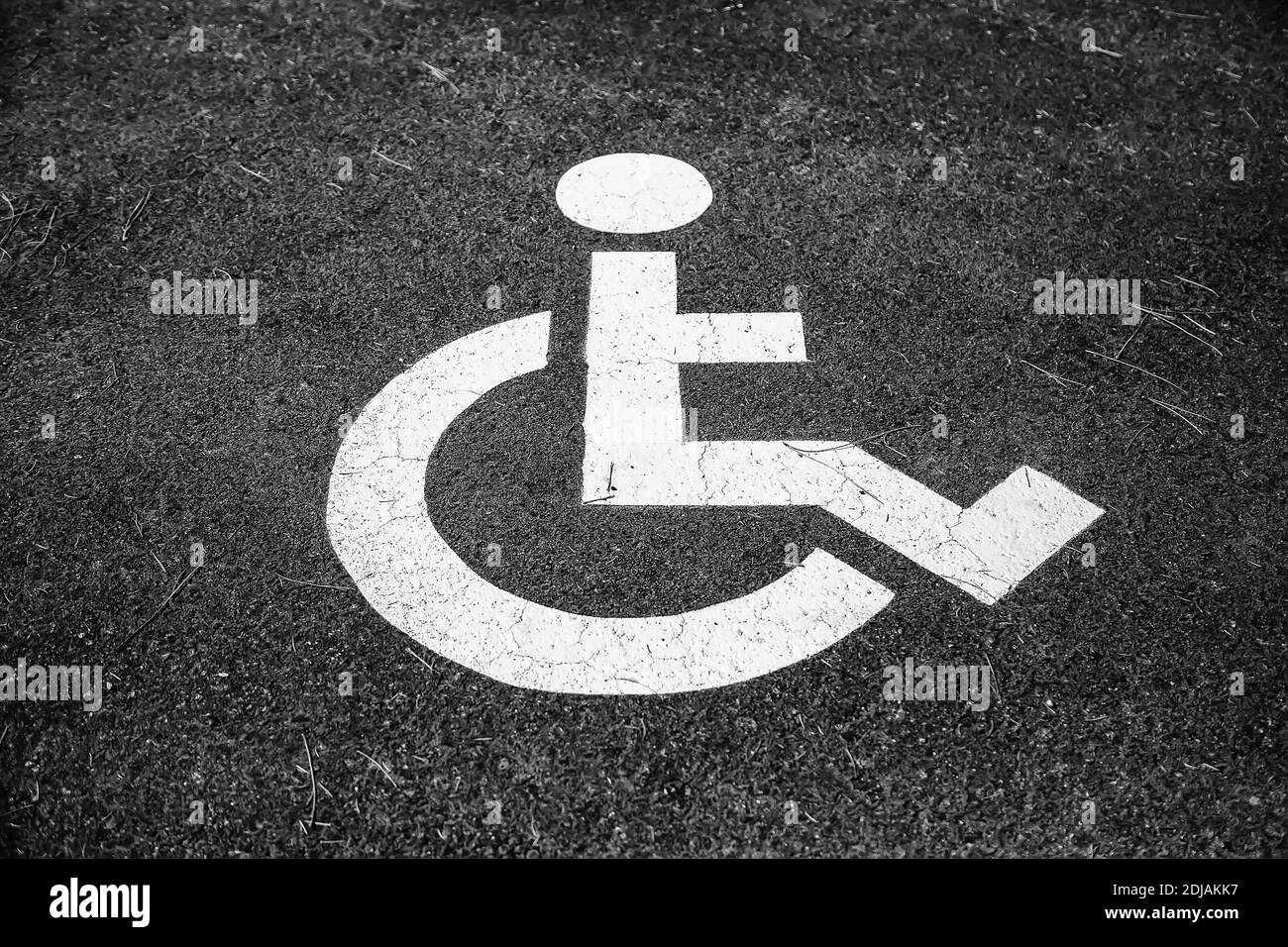 Disabled sign on the asphalt, detail of information and accessibility Stock Photo