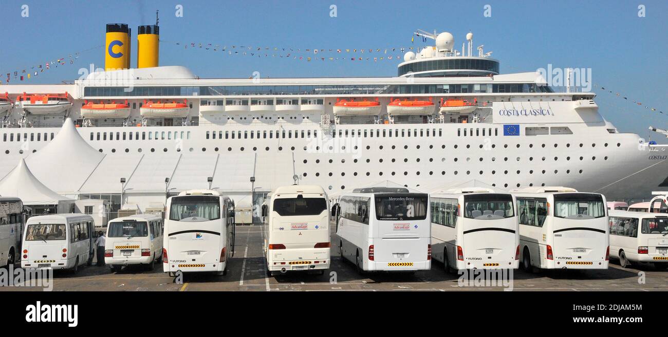 Cruise ship liner Costa Classica at Port Rashid row of bus coaches & mini buses  on dockside for passenger excursions Dubai United Arab Emirates UAE Stock Photo
