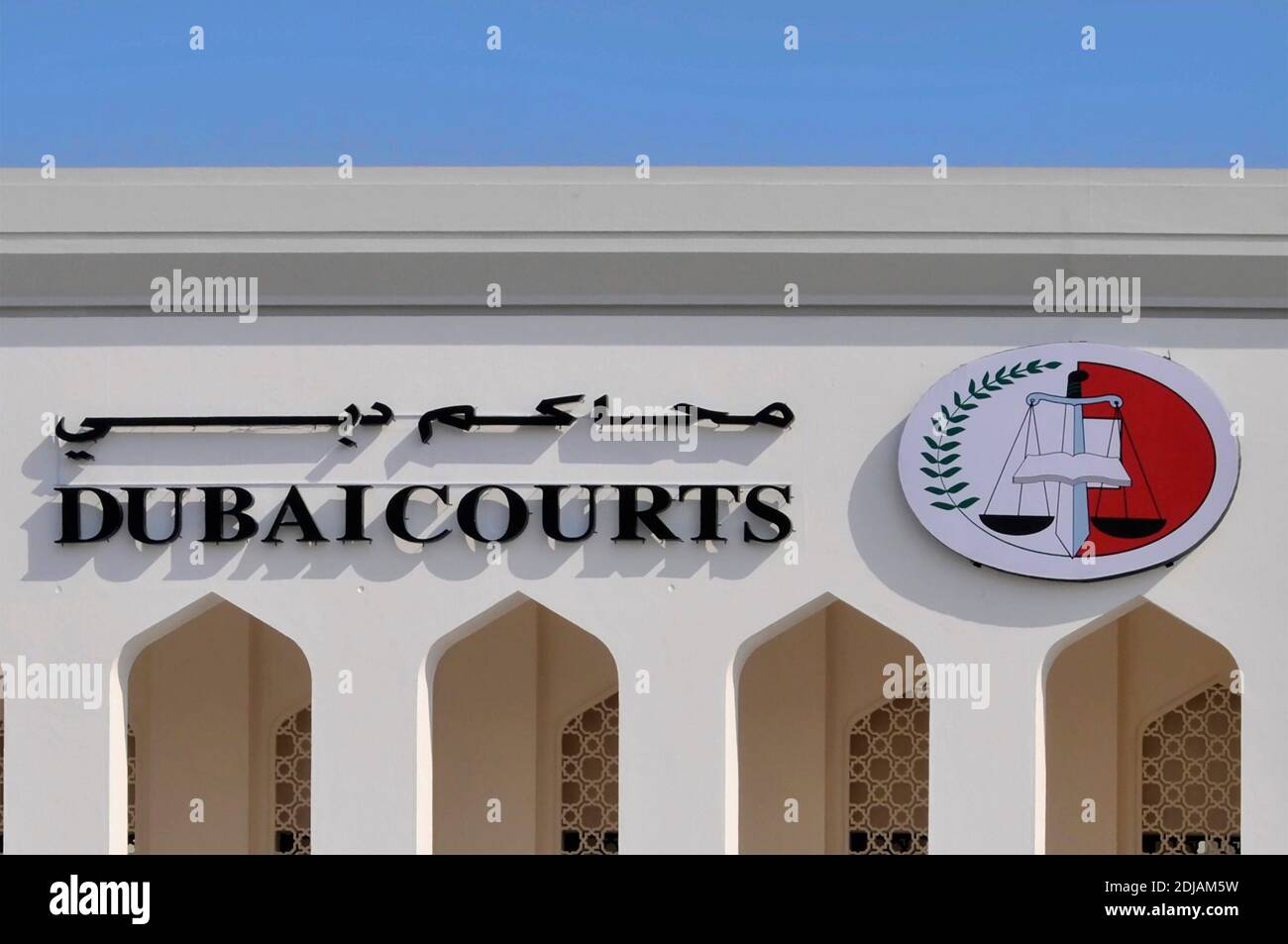Dubai close up part of Law Courts building bilingual sign & logo incorporates balancing scales of justice United Arab Emirates UAE Middle East Stock Photo