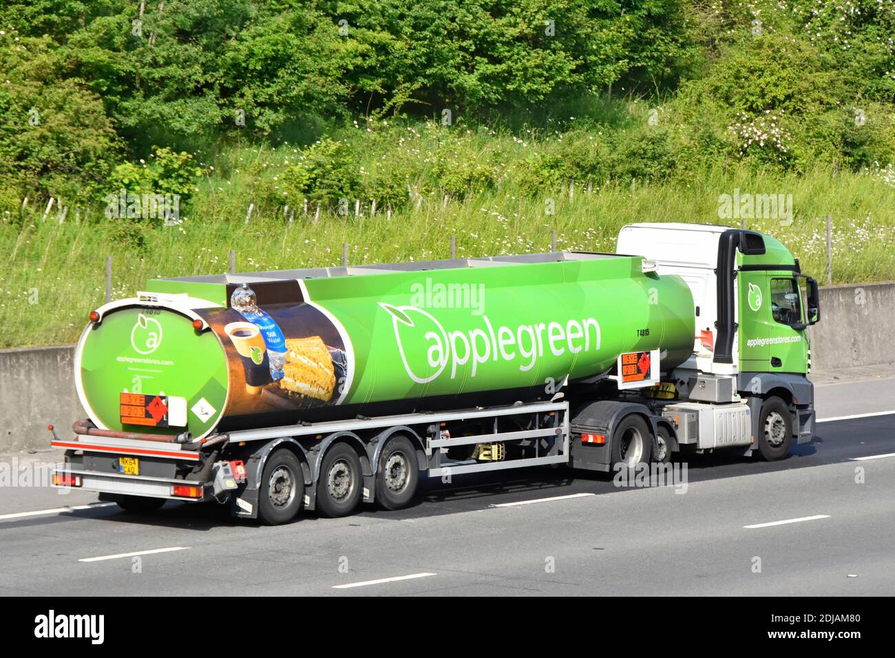 Side & back view Applegreen petrol fuel tanker supply chain filling station delivery lorry truck food & drink graphic on trailer driving UK motorway Stock Photo