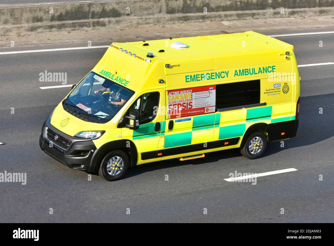 South East Coast NHS national health service emergency ambulance with Sepsis  information advert Fiat vehicle driving on trade plates on UK motorway Stock Photo