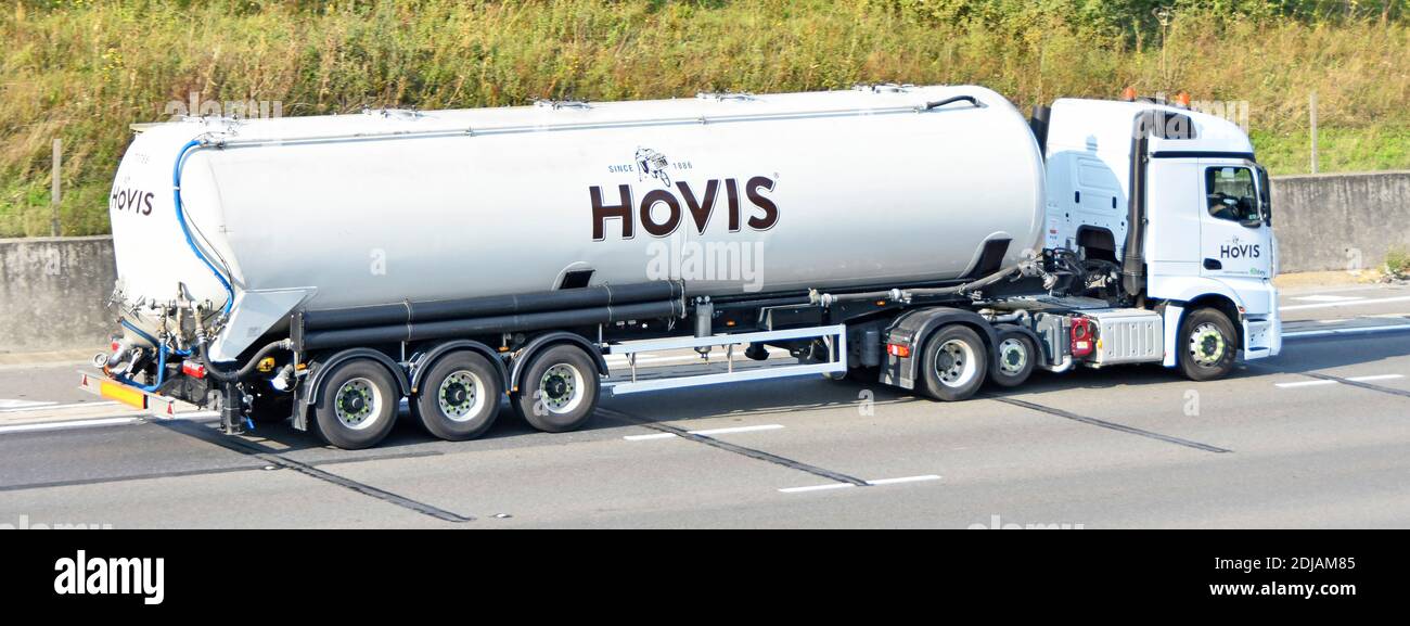 Hovis bread business brand bulk flour food supply chain articulated tanker trailer & lorry truck by Abbey logistics on UK motorway economy raised axle Stock Photo