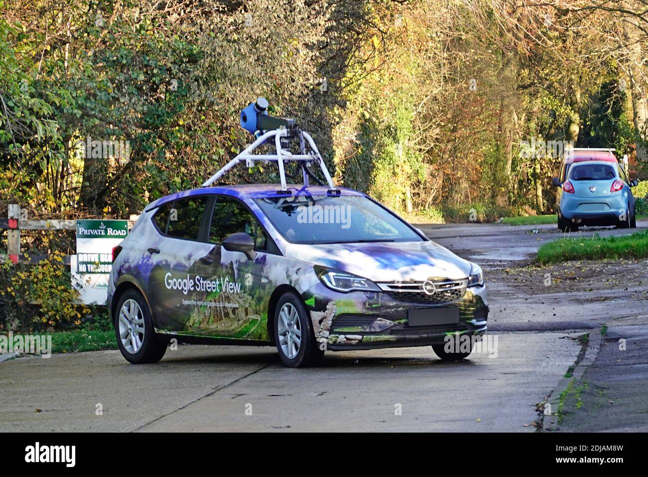Close up of Google car & video camera rig fixed into vehicle roof filming street view pegman map images driving residential road Essex England UK Stock Photo