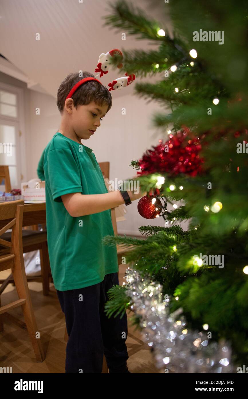 Family at home decorating their Christmas tree ahead of the Xmas festive period, United Kingdom Stock Photo