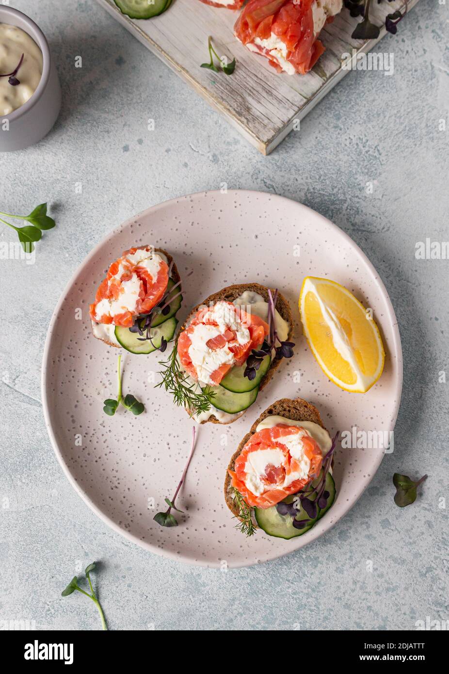 Mini open sandwiches with smoked salmon, cream cheese, cucumber and