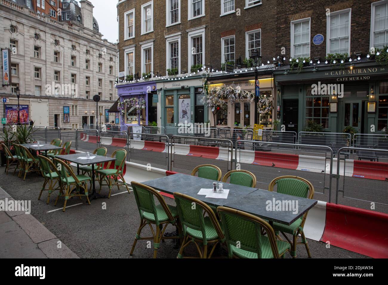 Empty restaurant tables sitting on Tavistock Street in Covent Garden as customers stay away due to the coronavirus pandemic, central London, England. Stock Photo