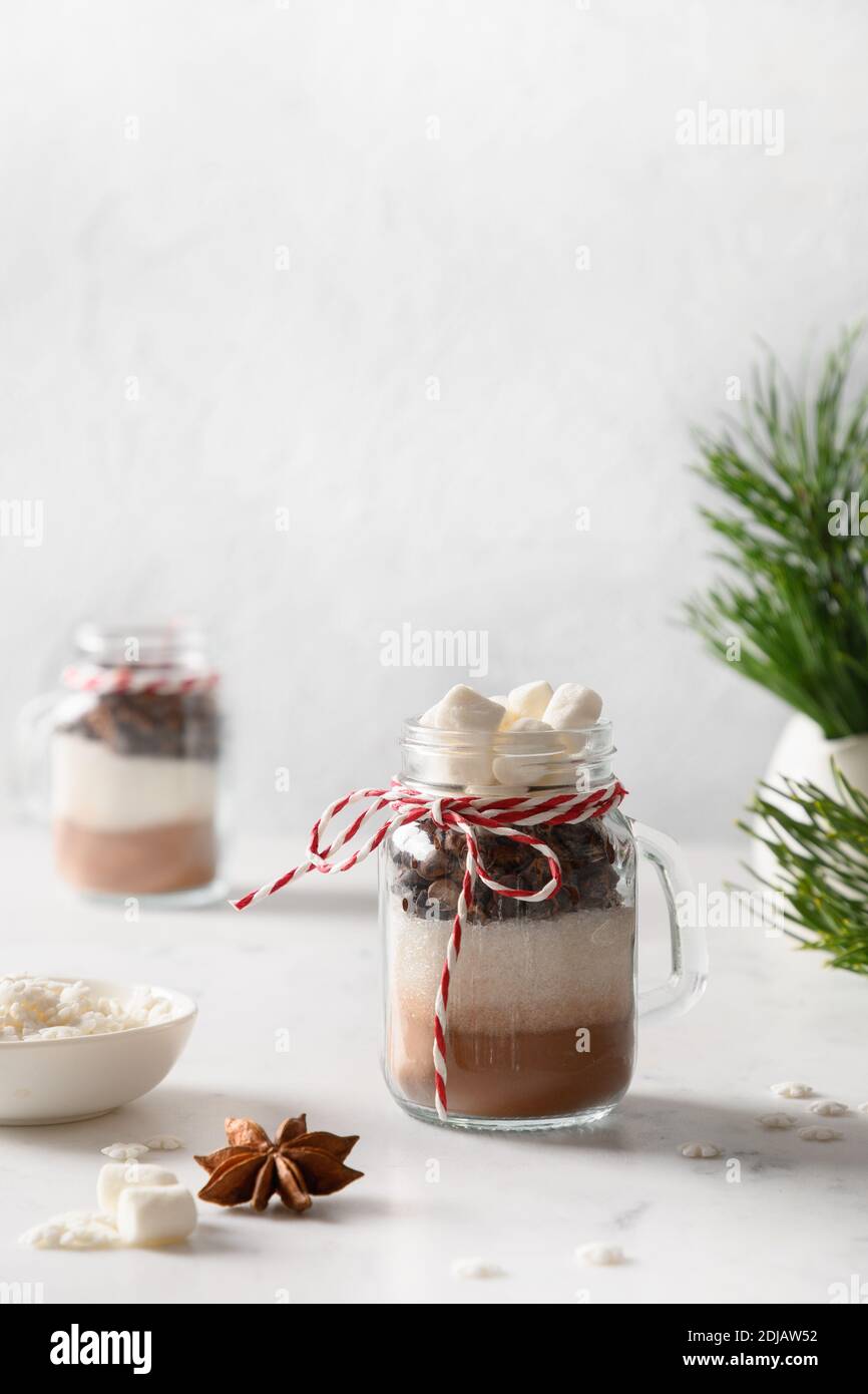 Christmas edible gift in glass jar for making chocolate drink on white