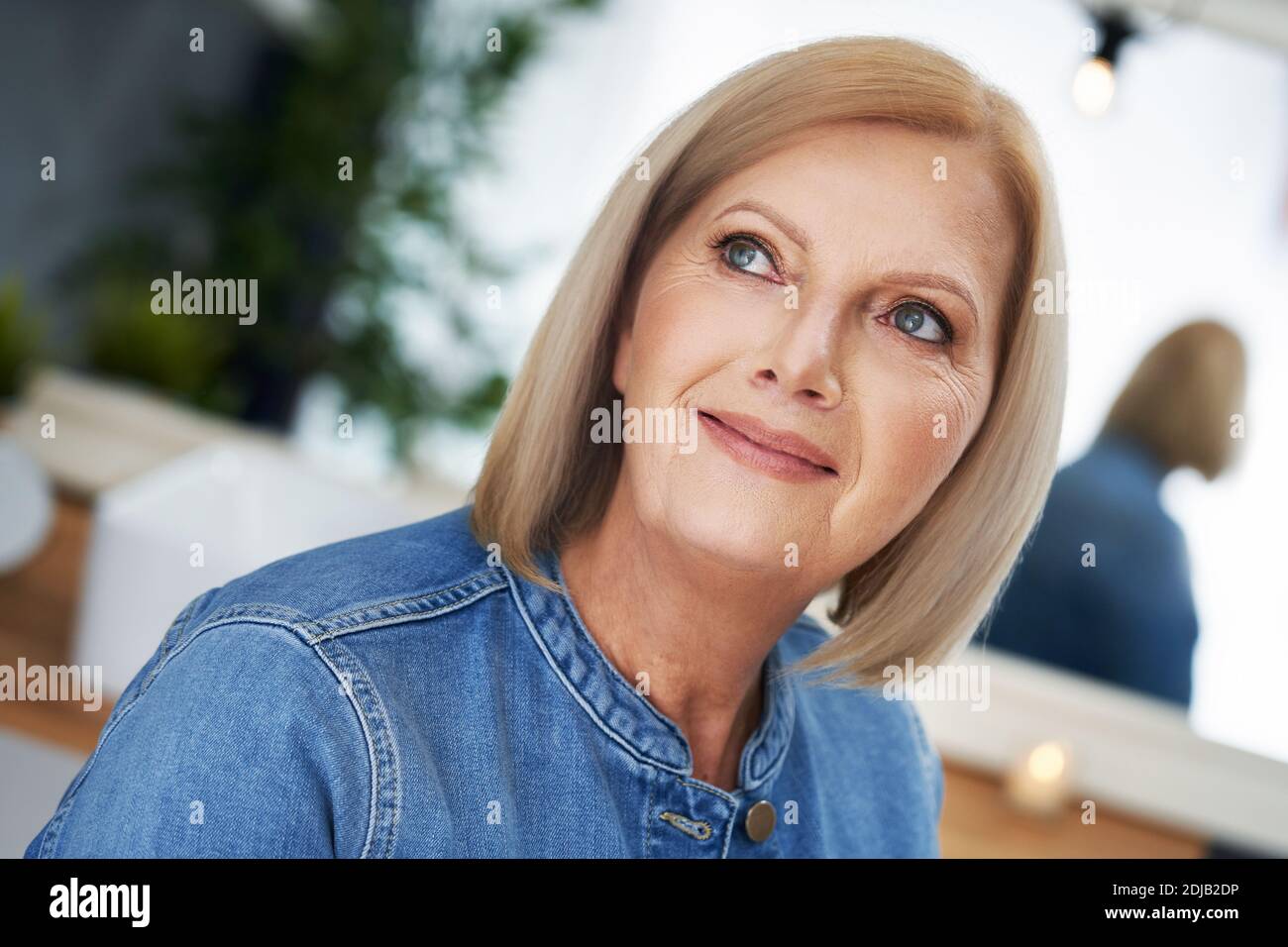 Senior woman posing in the bathroom Stock Photo