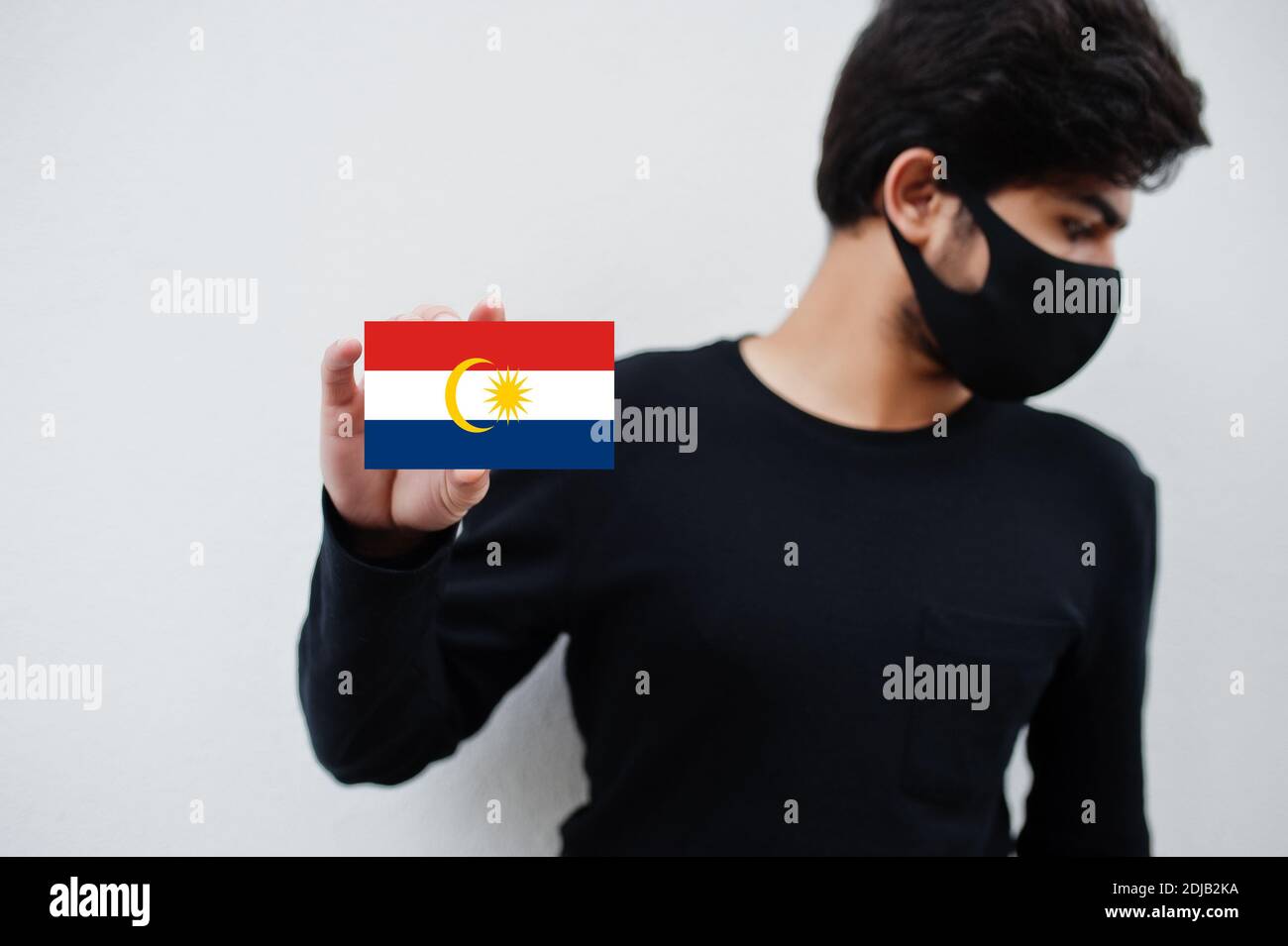 Malay Man Wear All Black With Face Mask Hold Labuan Flag In Hand Isolated On White Background States And Federal Territories Of Malaysia Coronavirus Stock Photo Alamy