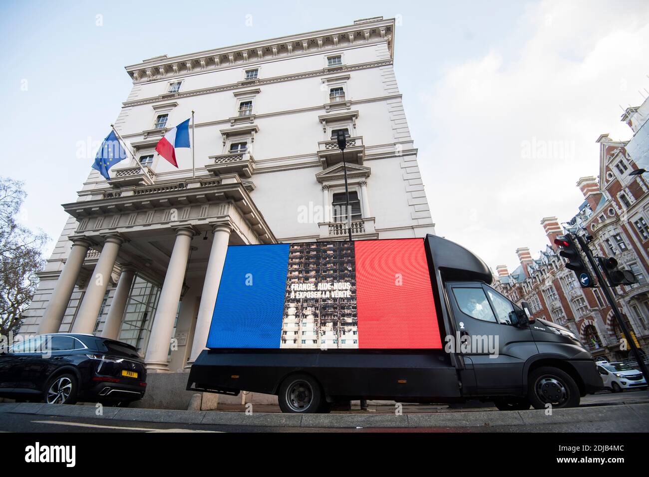 A Grenfell United campaign billboard at the French embassy in London delivering a message to the embassy urging them to demand witnesses for cladding firm Arconic residing in France to come to give evidence to the ongoing Grenfell Tower inquiry. Stock Photo