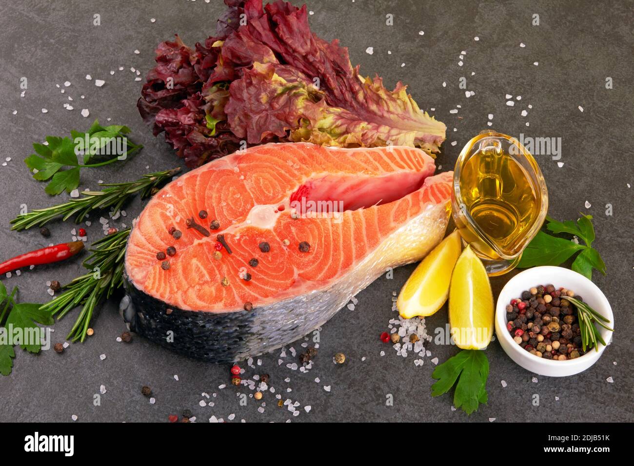 Salmon steak on a black background with spices Stock Photo - Alamy
