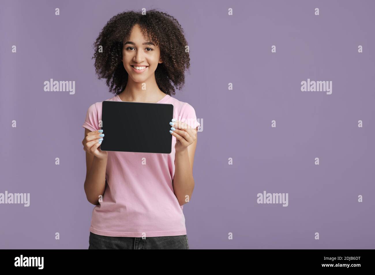 Reviews, offers and online application. Happy female shows tablet with blank screen Stock Photo