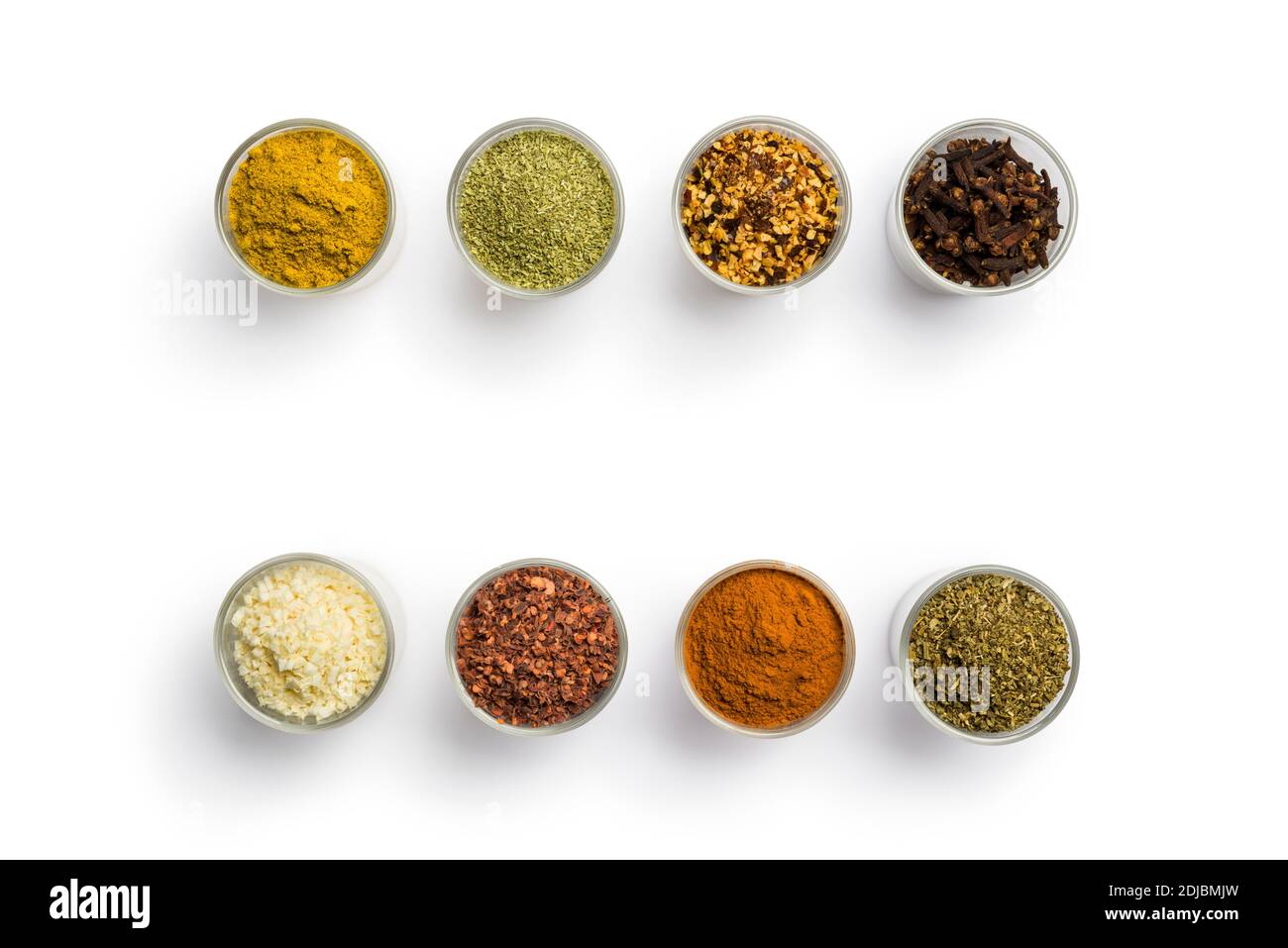 top view of glass jars with various spices on white background Stock Photo