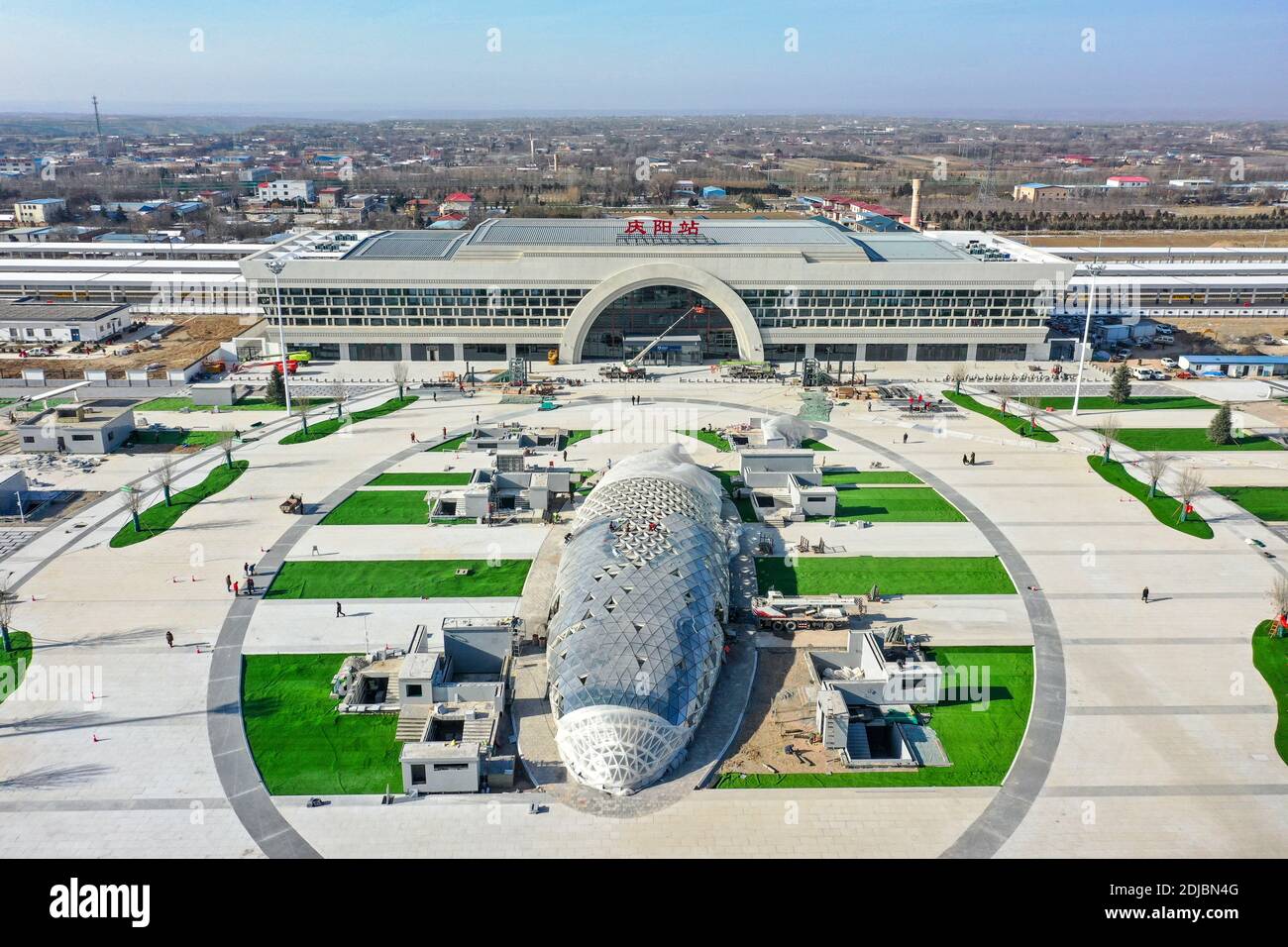 Yinchuan. 14th Dec, 2020. Aerial photo taken on Dec. 14, 2020 shows a view of the Qingyang Railway Station along the Yinchuan-Xi'an high-speed railway in Qingyang City, northwest China's Gansu Province. The Yinchuan-Xi'an high-speed railway and the stations along the line will be put into service soon. Credit: Feng Kaihua/Xinhua/Alamy Live News Stock Photo