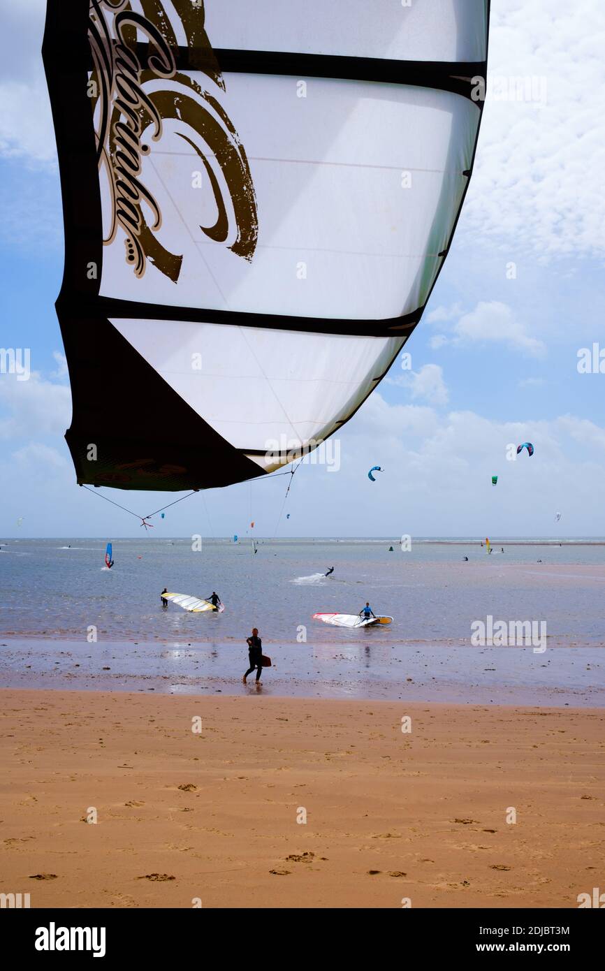 Kitesurfing or kiteboarding on a windy day in Exmouth, Devon, England