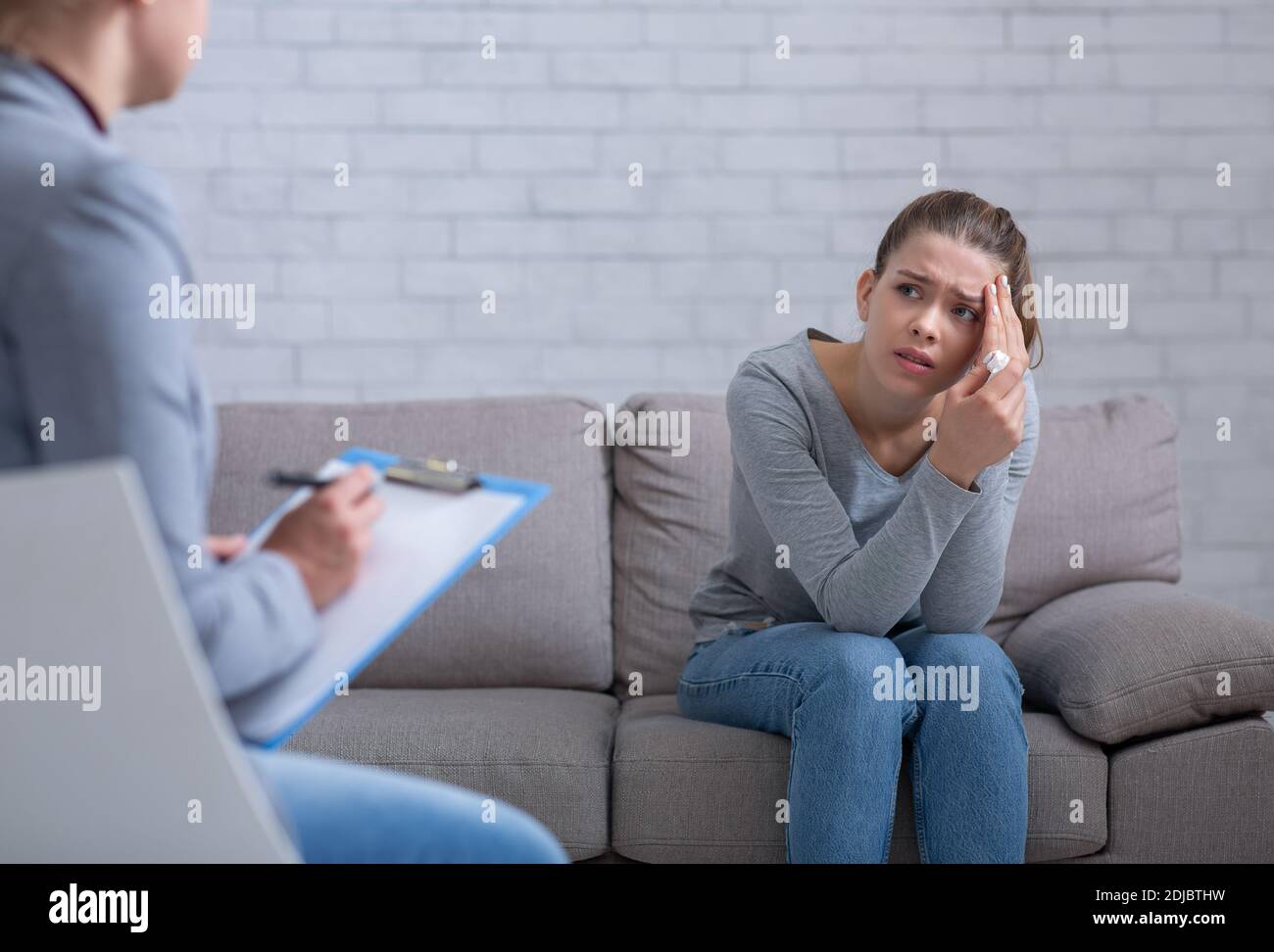 Psychological counselling. Female patient with depression having session with her psychotherapist at office Stock Photo
